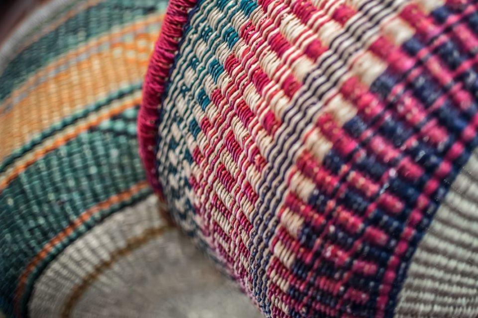 A close-up of woven baskets in many muted colors