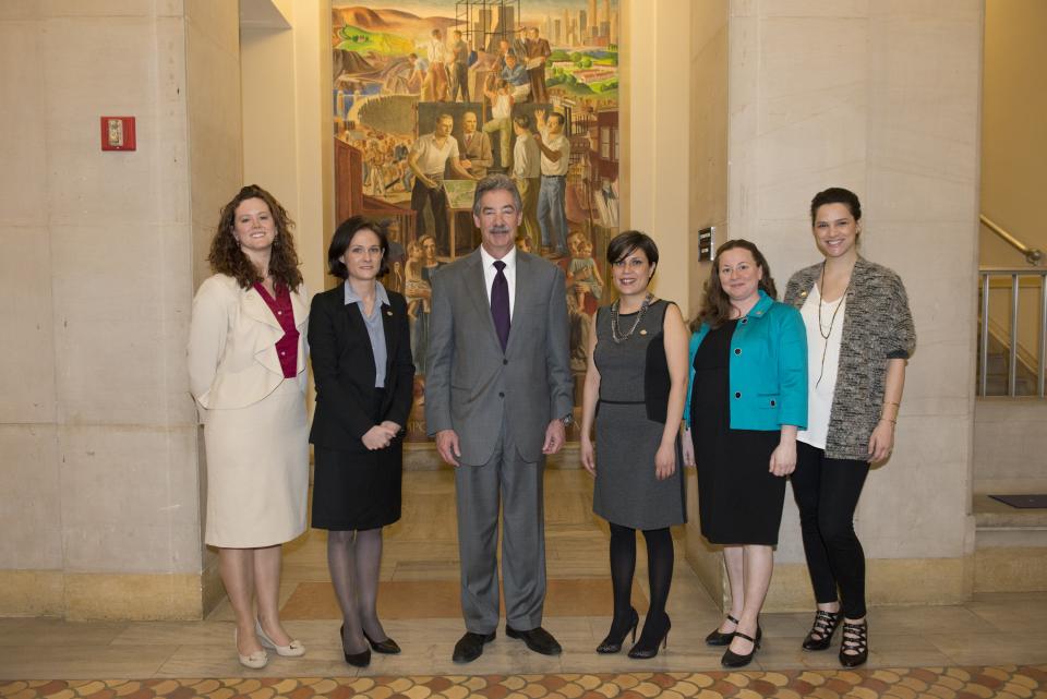 Staff from DC SAFE, a 2014 National Crime Victim Service Award recipient, appear with Deputy Attorney General James M. Cole.